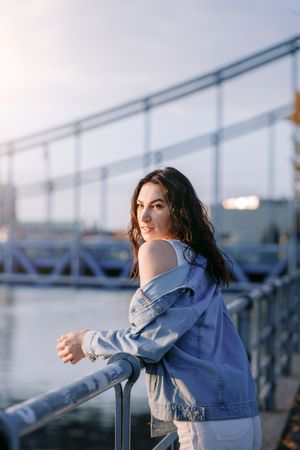 Woman enjoying view  on the waterfront at sunset