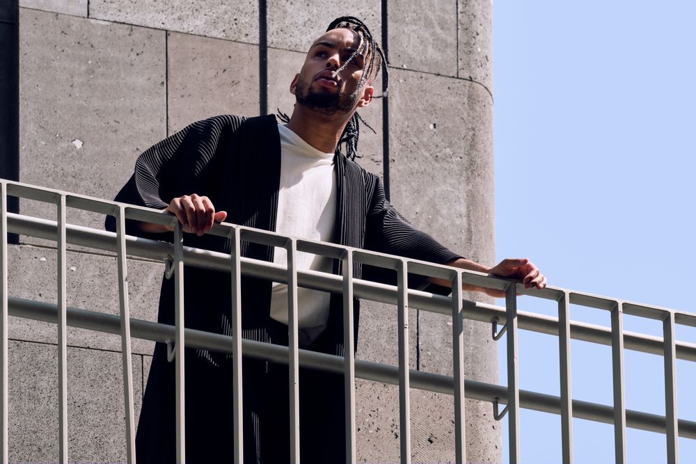 Black male standing on bridge