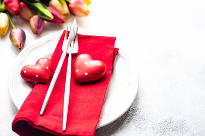 Heart decorations and tulips on table setting