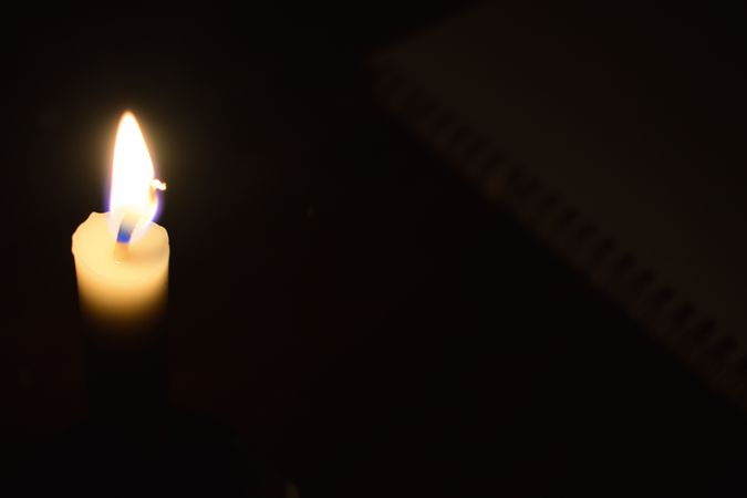 Top view of candle burning in the dark with copy space
