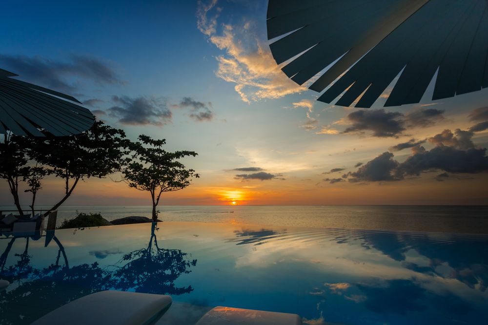 Infinity pool near ocean during sunset