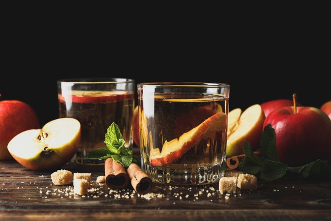 Composition with cider, sugar, cinnamon and apples on wooden table