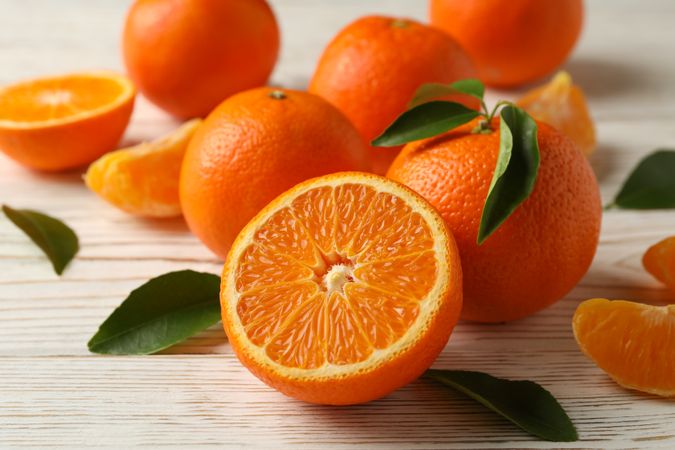 Ripe sweet mandarins on wooden background, top view