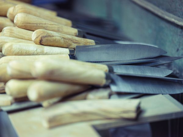 Pile of sharp knives in blacksmith workshop