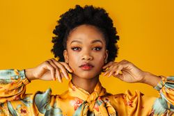 Beautiful Black woman holding her hands to either side of her face