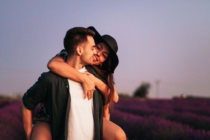 A romantic photograph of a couple in a lavender field
