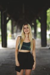 Blonde cheerful model standing and looking at camera
