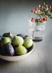 Plate of fresh ripe figs on kitchen table