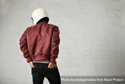 Rearshot of man in dark red leather jacket wearing helmet with hands in back pocket 4Oz8j5