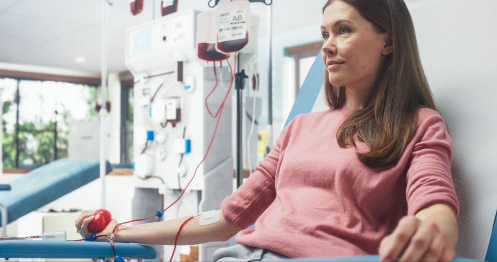 Woman Donating Blood For People In Need In Hospital.