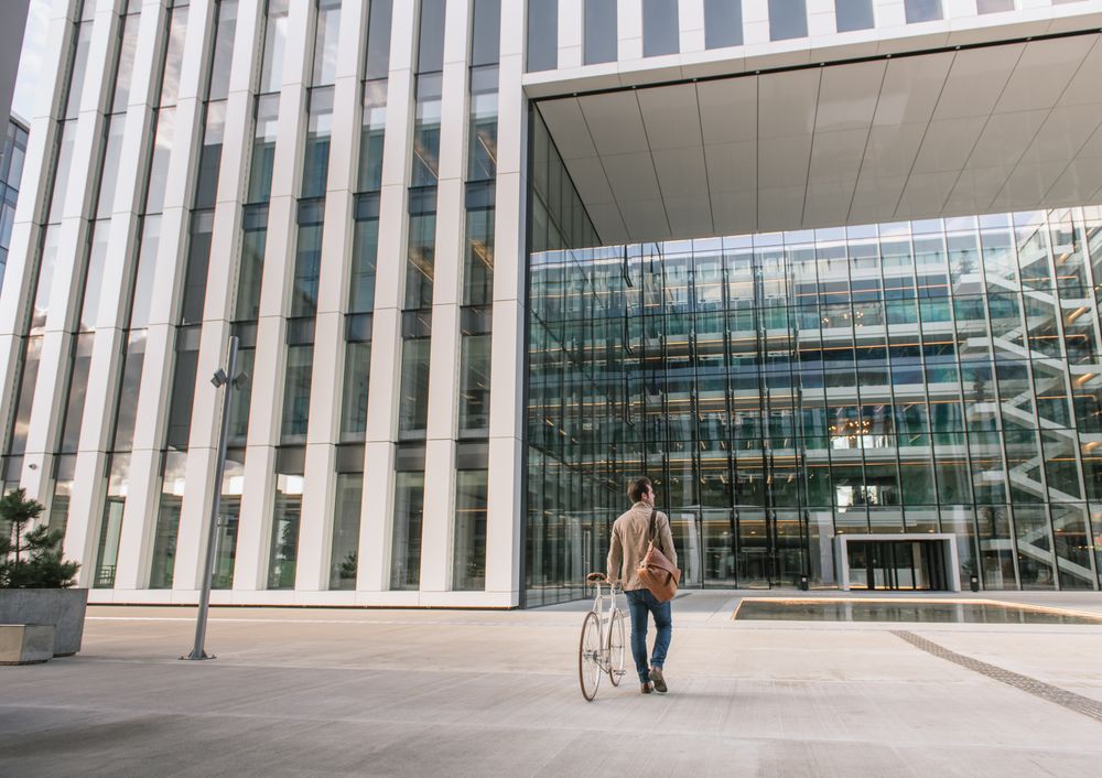 Businessman walking on street with bicycle