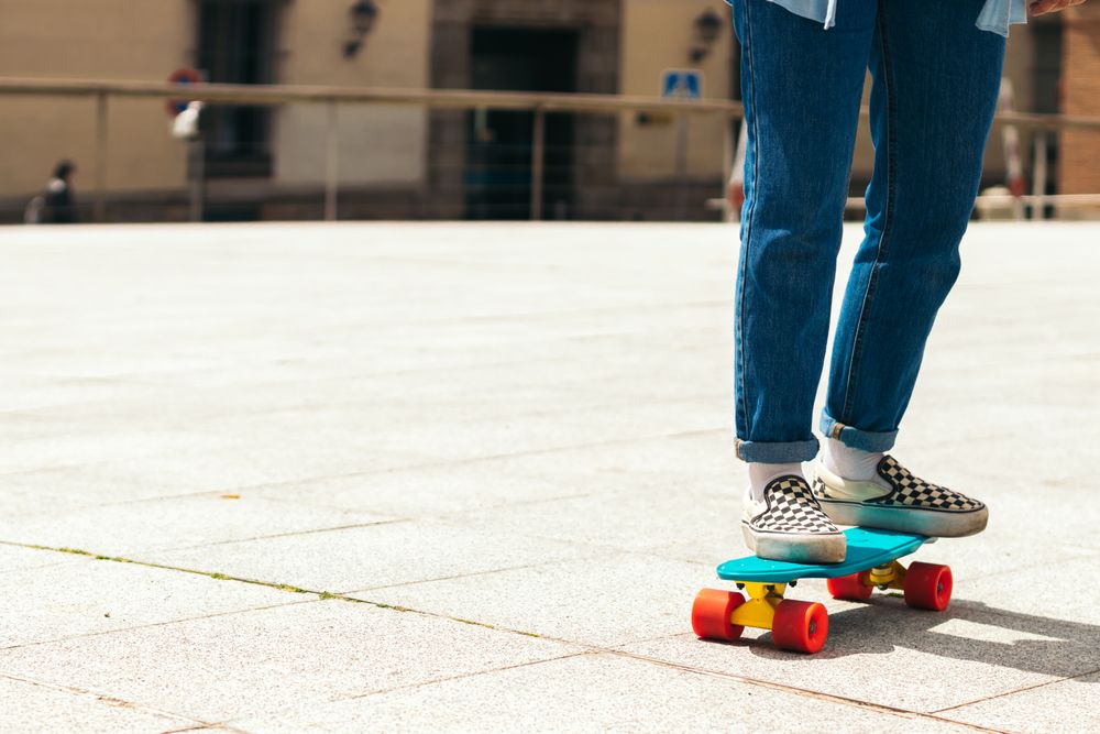 Legs of women skating in a urban square, close-up