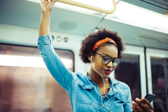 Woman checking phone on public transport