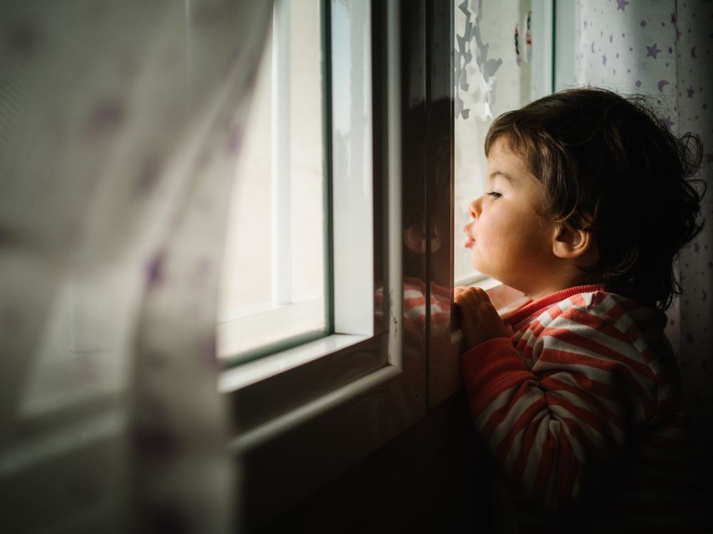 kid peering through window