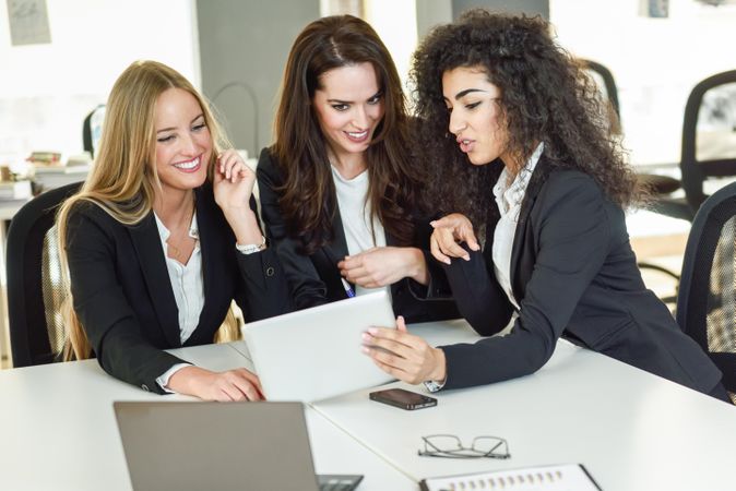 Female team of business leaders working in office on project