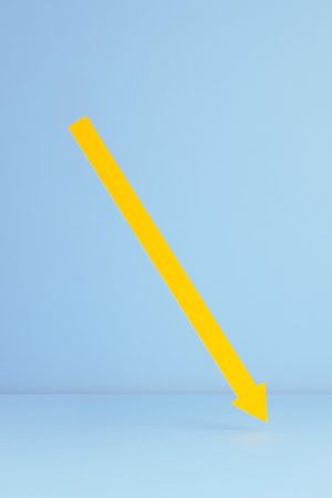 Yellow paper arrow over blue background