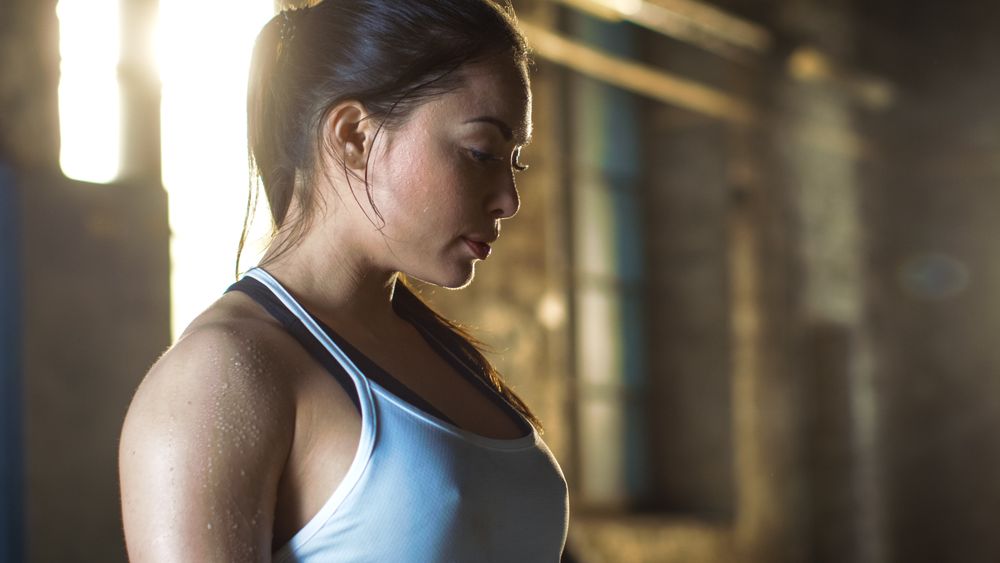 Tired Athletic Woman Looking Down after Intensive Cross Fitness Exercise.