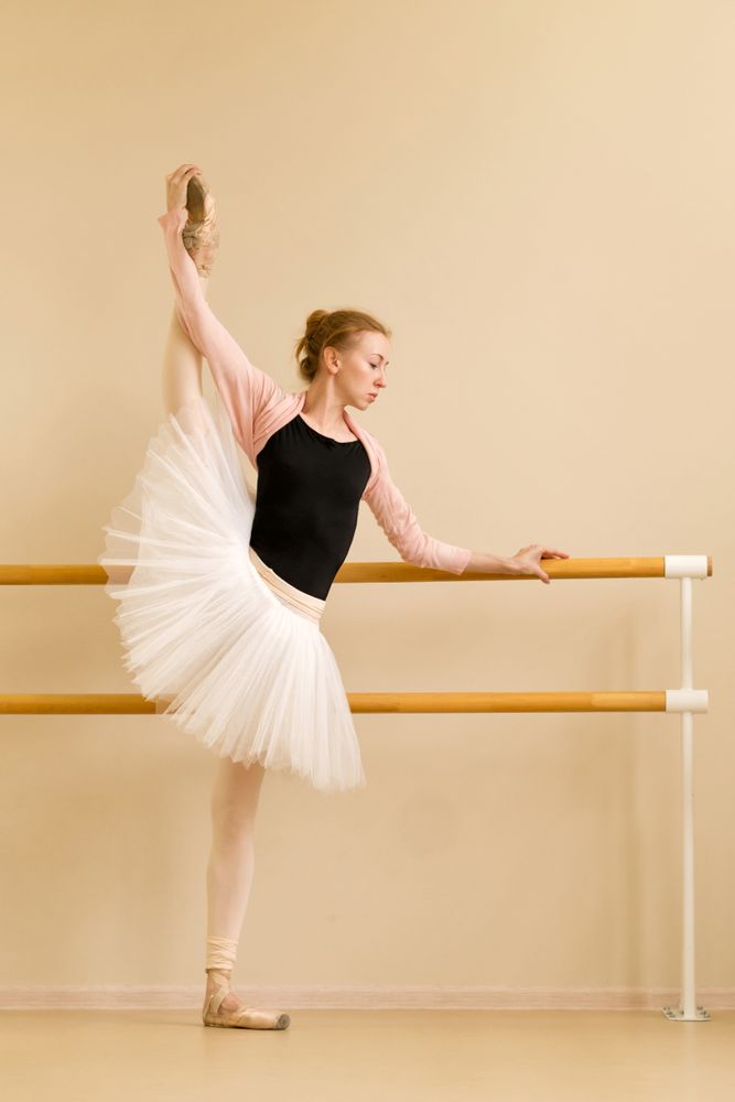 Ballerina holding high leg stretch