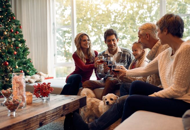 Happy family celebrating Christmas eve with wine