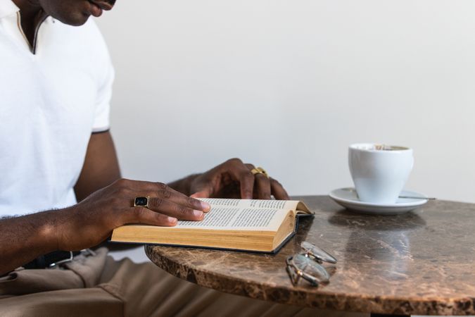 Black male reading book in cafeteria