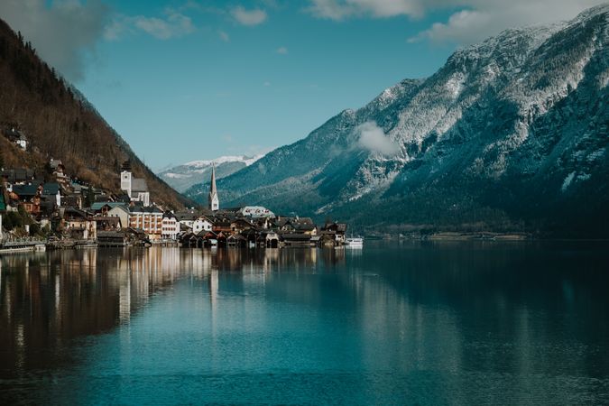 Mountain coast with houses along turquoise lake
