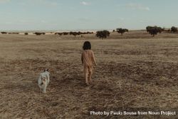Child and her dog in a field 0ydR1b