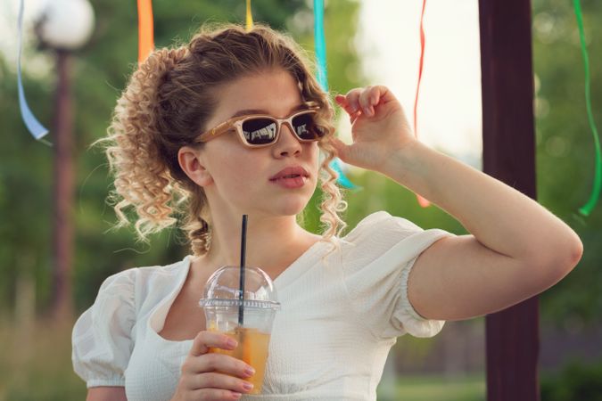 Woman with drink outdoors