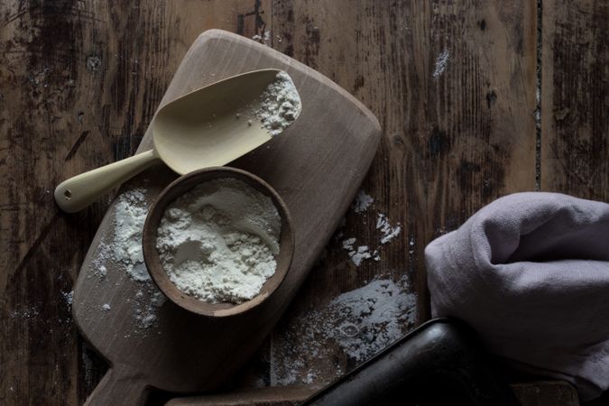Flour and cooking utensils on wooden table