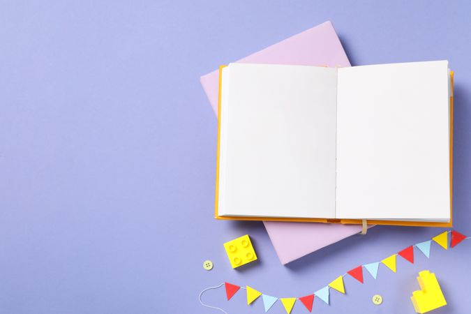 Children's book, with toys, on a purple background.