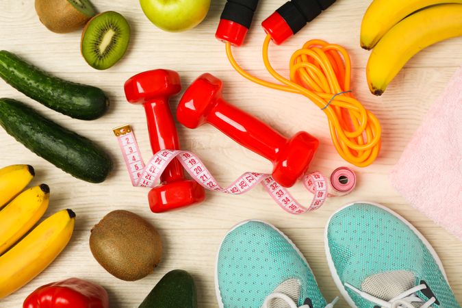 Healthy lifestyle accessories on wooden background, top view