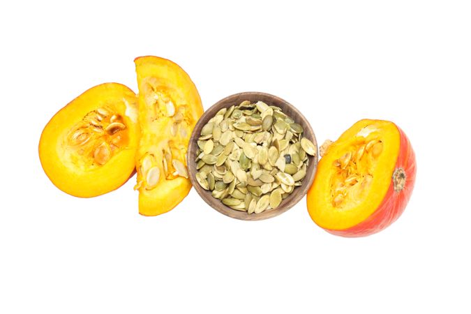 Fall season food - pumpkin seeds, isolated on light background