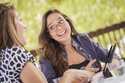 Happy Women Working Together on Tablet Computer