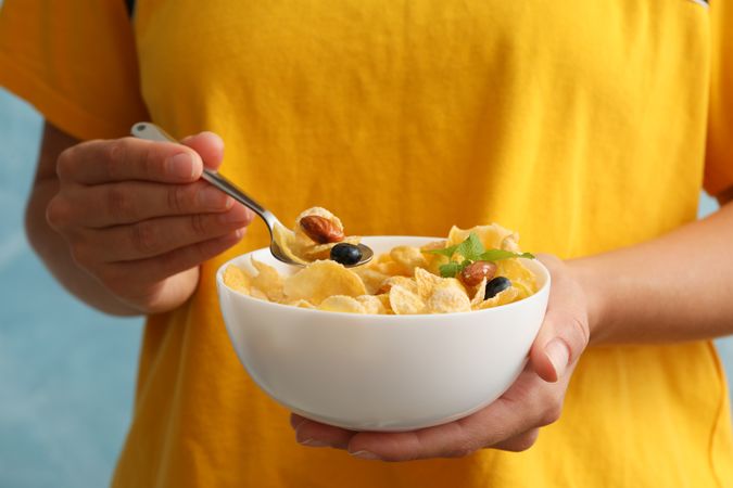 Woman hold bowl of muesli, close up