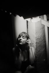 Silhouette of sensual woman leaning in shadow