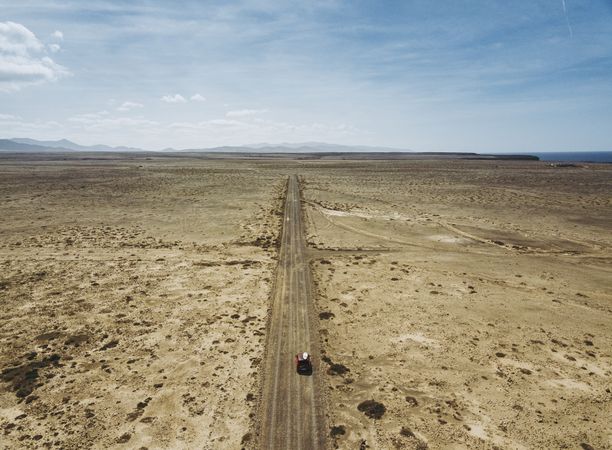 Car driving on road in picturesque desert