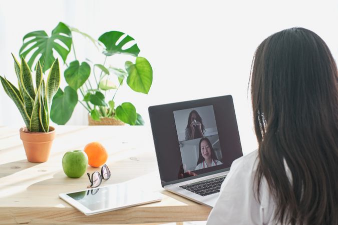 Asian therapist making video call with patient