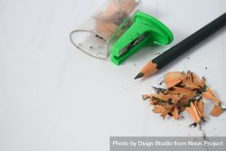Pencil on table with shavings & green sharpener with copy space 48BaRZ