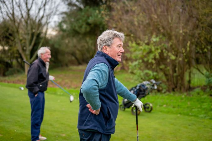 Mature men looking ahead on golf course