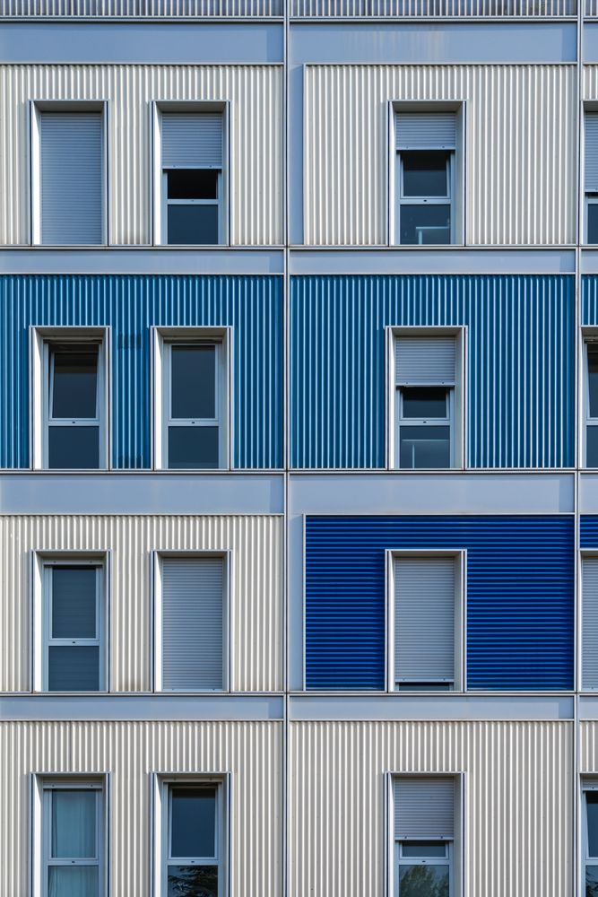 Facade of modern multicolored building with narrow windows