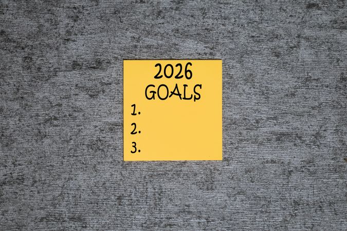 2026 plan words text on yellow sticky notes blocks on grey table background
