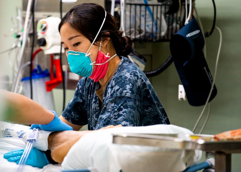 Los Angeles, CA, USA - April 28, 2020: Lt. j.g. adjusts a pillow aboard USNS Mercy
