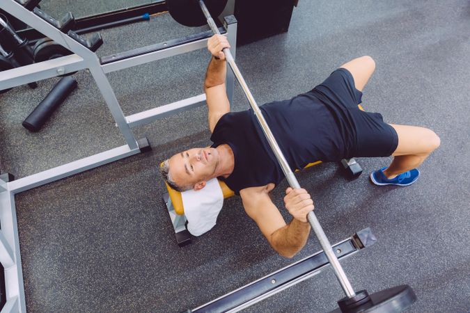 Top view of male bench pressing in gym