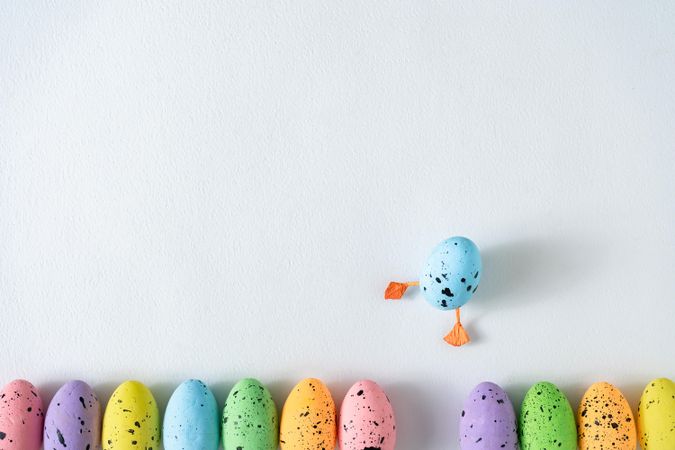 Pastel eggs row on light background