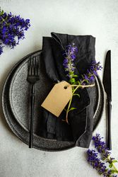 Summer background with blue flowers on dark table setting