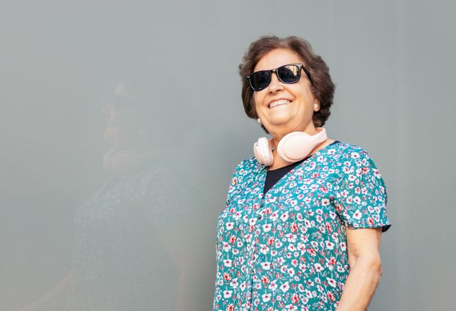 Stylish older woman in sunglasses and colorful clothes