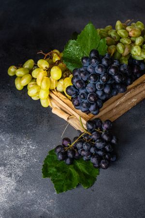 Box of delicious fresh green & red grapes with leaves
