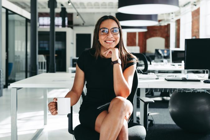 Confident businesswoman smiling at the camera in a modern workplace