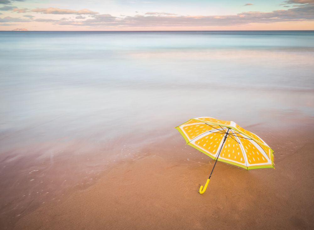 Umbrella on beach near sea