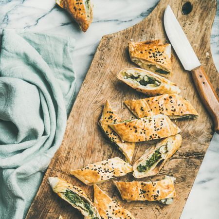 Turkish pastry, borek, sliced on wooden board