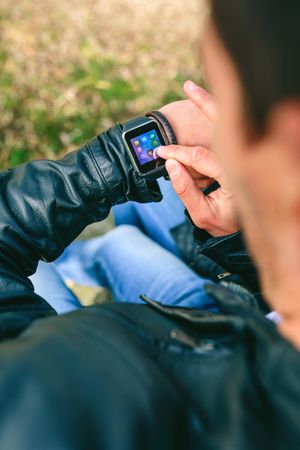Unrecognizable young man using his smartwatch